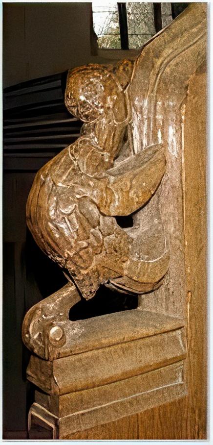 A bird on a bench end - All Saints, Thornham